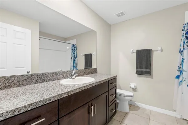 a bedroom with two beds and a couch