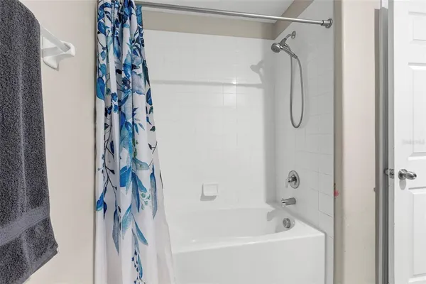 an empty room with window and ceiling fan