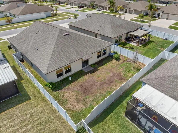 an aerial view of residential houses with outdoor space