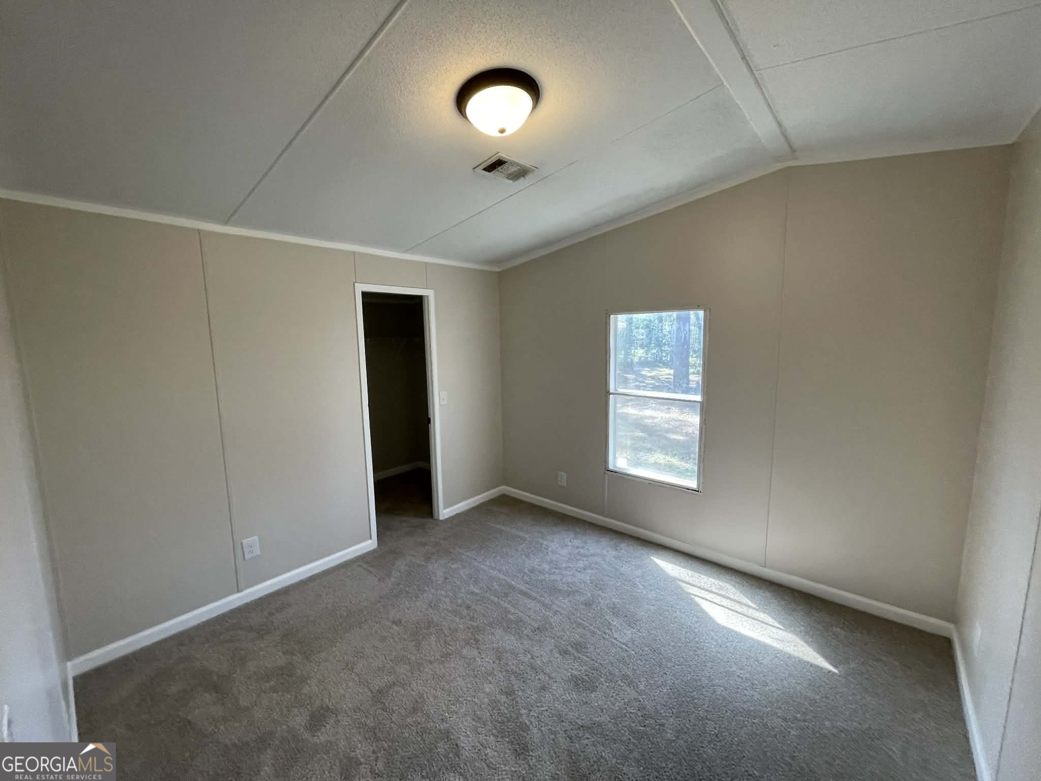 105 Senimor Court Perry, GA 31069 - Photo 21 of 27 an empty room with a ceiling fan and windows