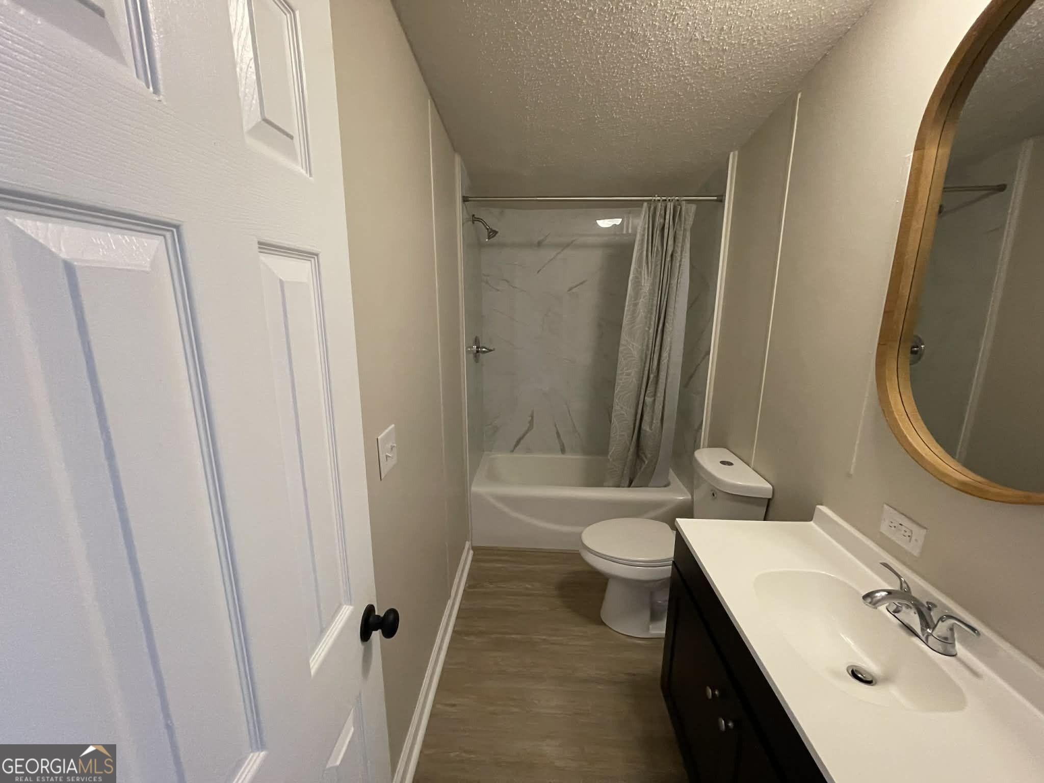 105 Senimor Court Perry, GA 31069 - Photo 24 of 27 a bathroom with a sink a toilet a mirror and shower