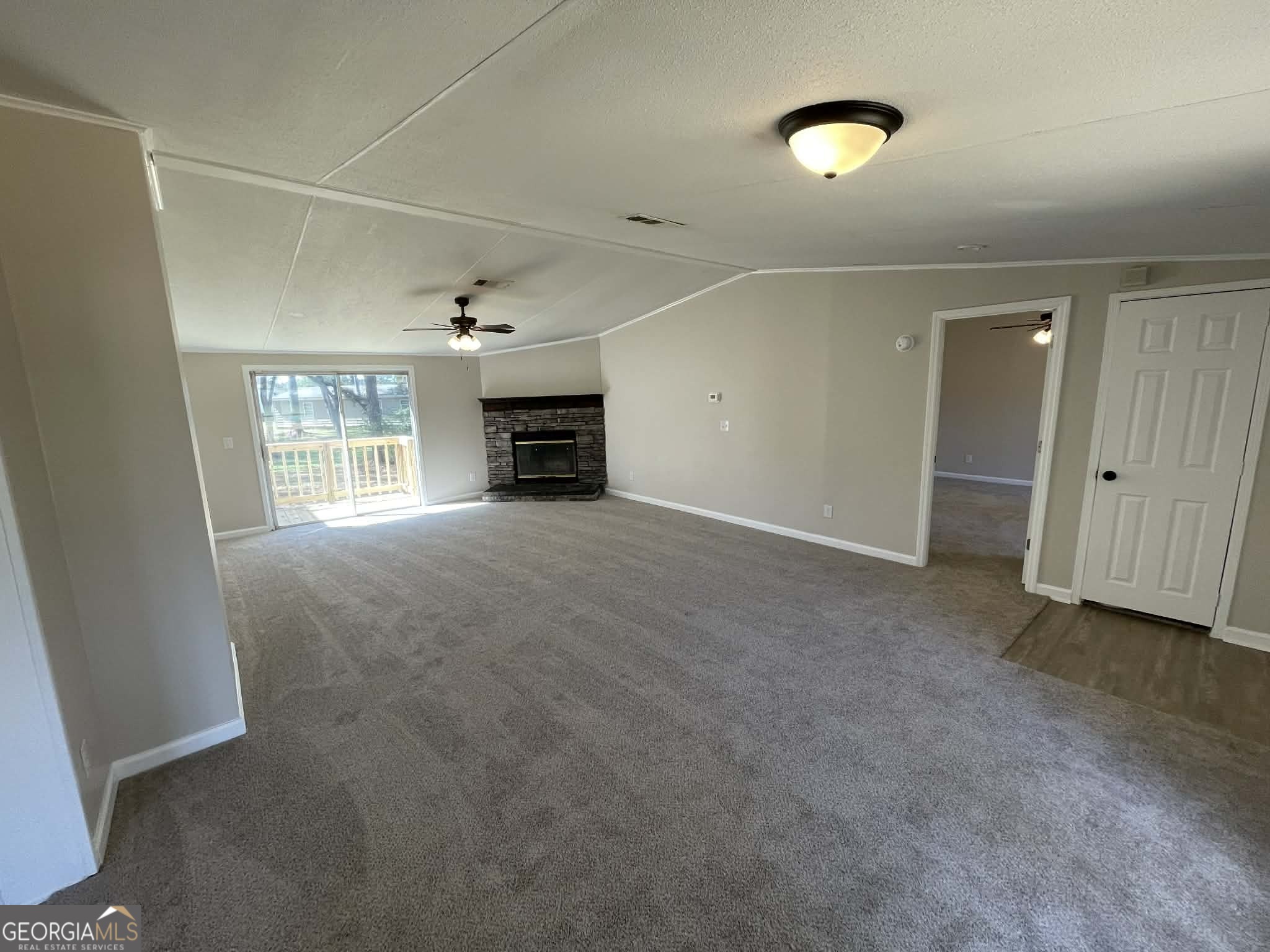 105 Senimor Court Perry, GA 31069 - Photo 6 of 27 an empty room with fireplace and windows