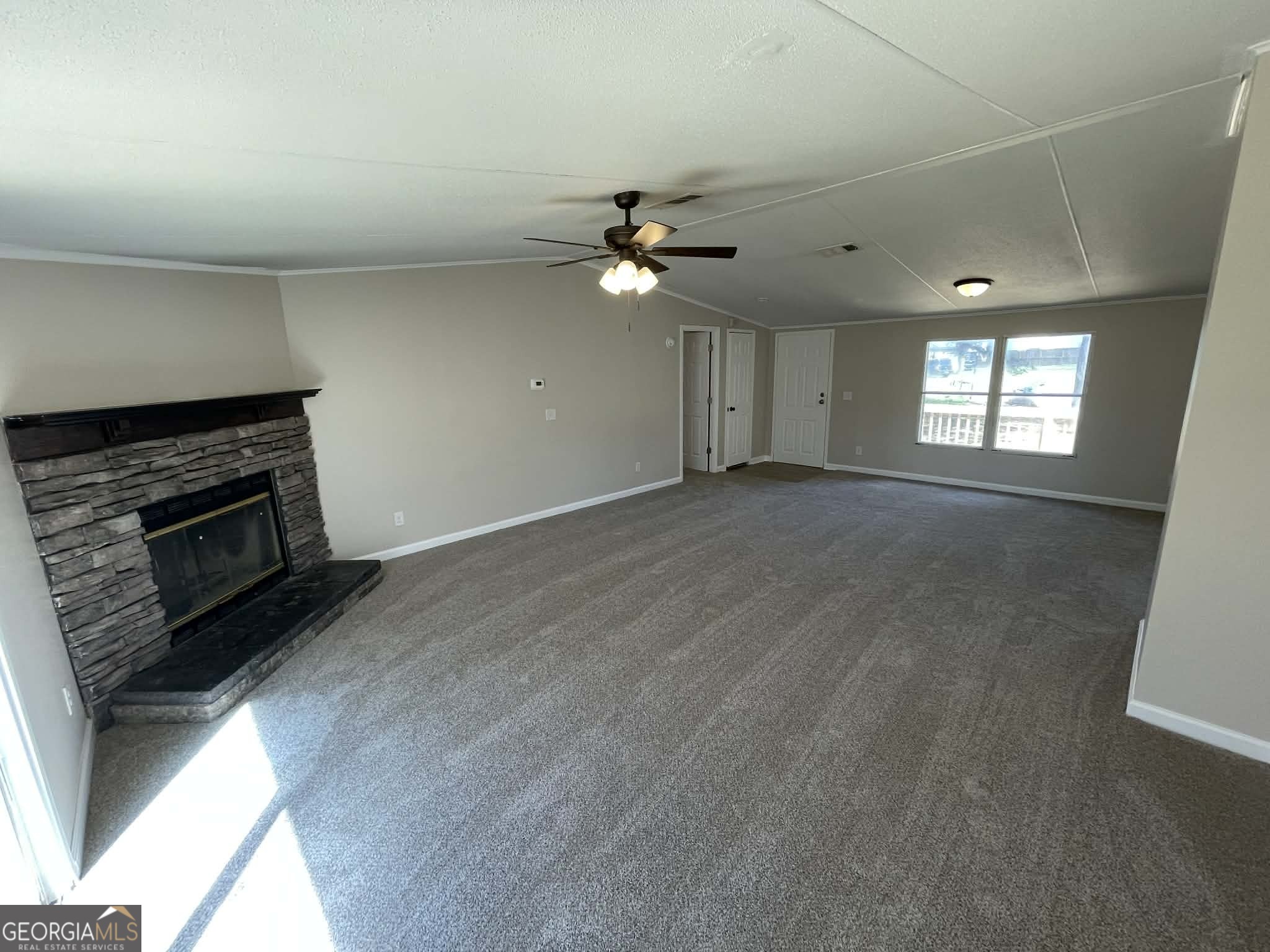 105 Senimor Court Perry, GA 31069 - Photo 7 of 27 an empty room with windows and fireplace