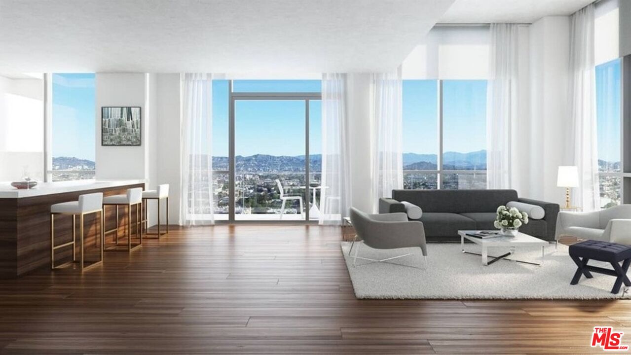 3033 Wilshire Boulevard, Unit 802 Los Angeles, CA 90020 - Photo 4 of 31 a living room with furniture and a large window