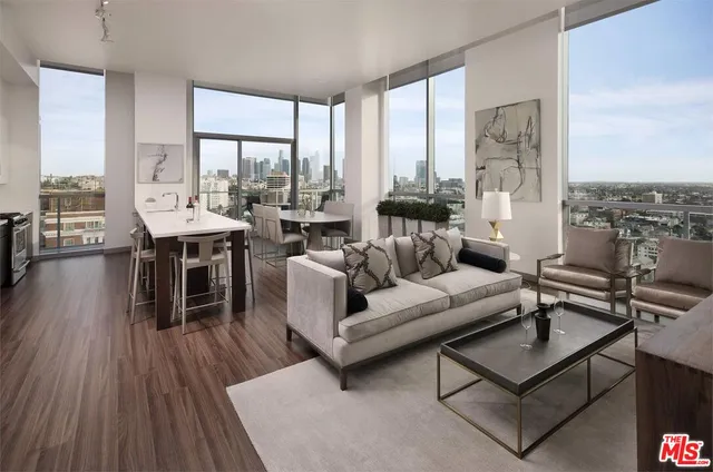 a living room with furniture a large window and a table
