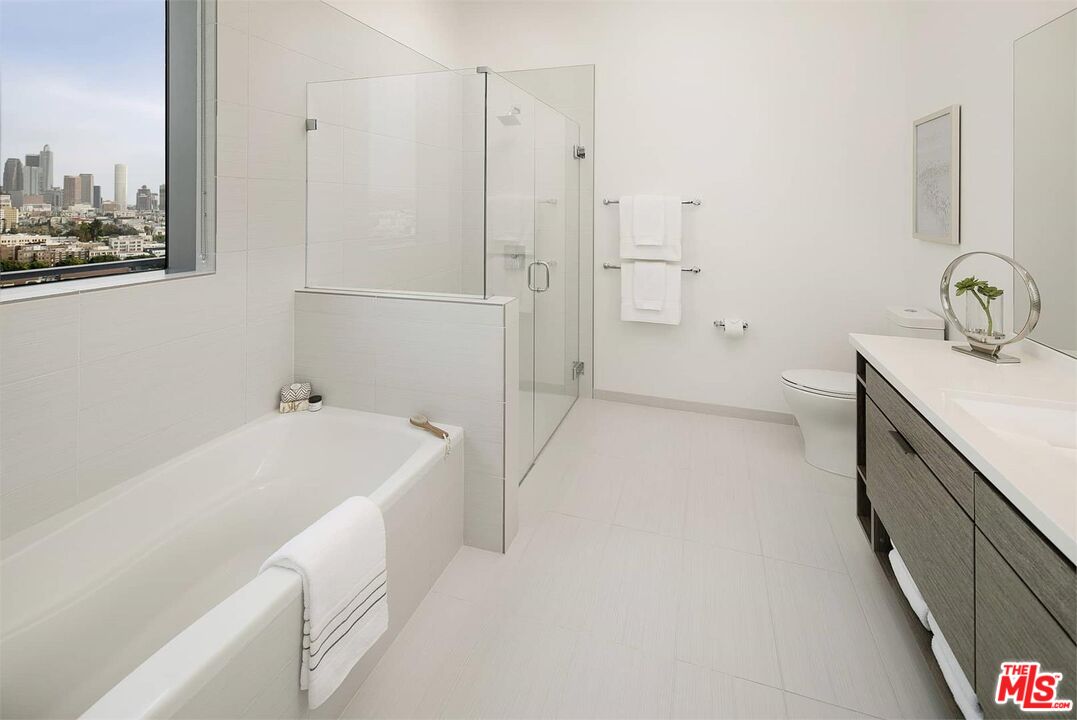 3033 Wilshire Boulevard, Unit 802 Los Angeles, CA 90020 - Photo 9 of 31 a bathroom with a tub sink and mirror
