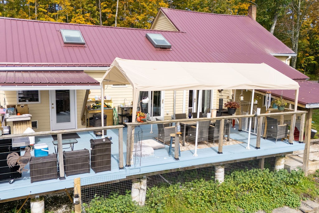 1668 Vandervort Hill Road Unadilla, NY 13849 - Photo 41 of 50 A spacious elevated deck extends along the back of this home under a metal roof.