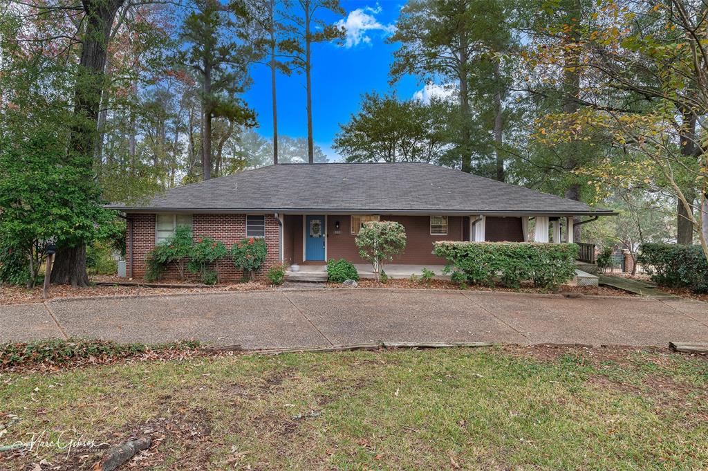 400 Southfield Road Shreveport, LA 71106 - Photo 2 of 30 a view of a house with a yard plants and large tree