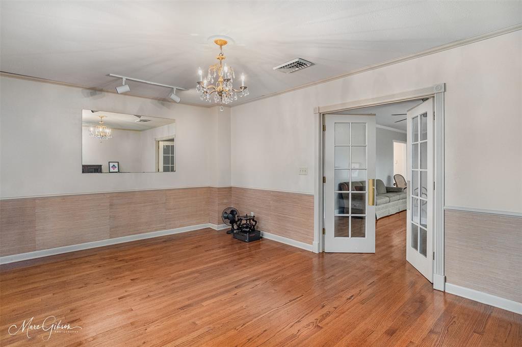 400 Southfield Road Shreveport, LA 71106 - Photo 9 of 30 a view of a room with wooden floor and a ceiling fan