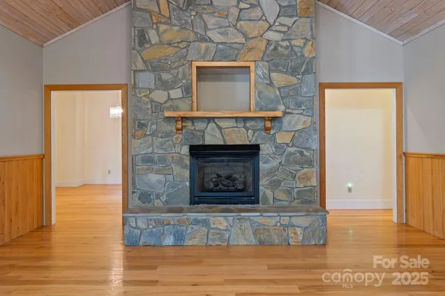 a living room with a fireplace and a wooden floor