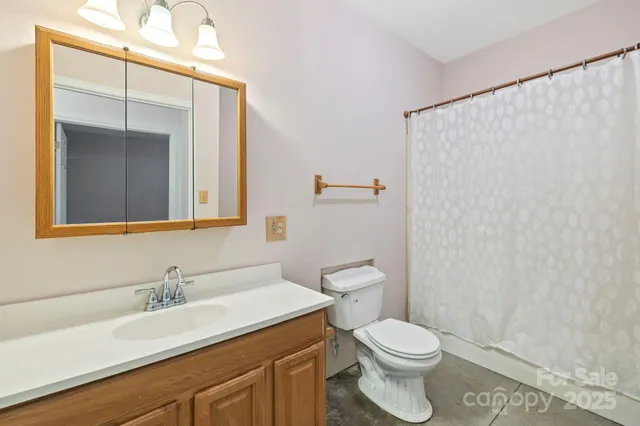 a bathroom with a toilet a sink and a mirror