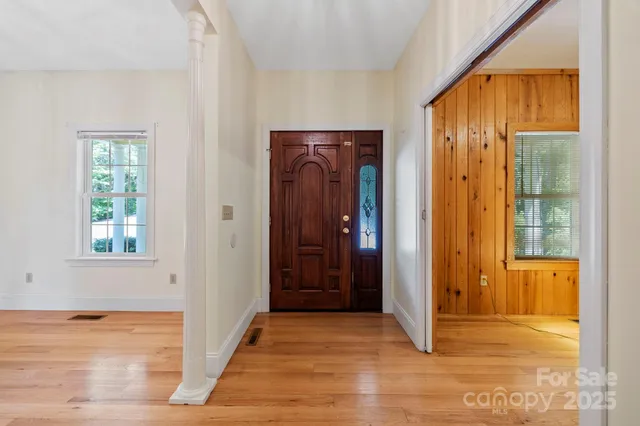 an empty room with windows and closet