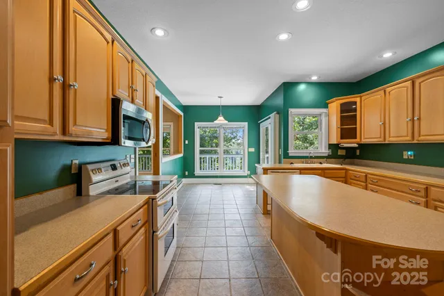 a kitchen with stainless steel appliances granite countertop a sink and cabinets