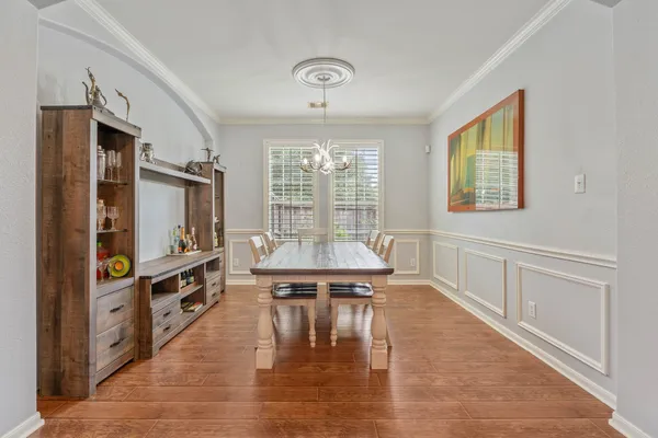 a living room with stainless steel appliances furniture a large window and a flat screen tv