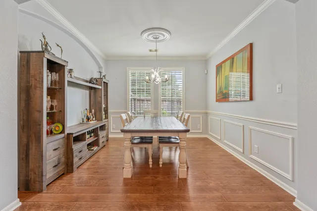 a living room with stainless steel appliances furniture a large window and a flat screen tv