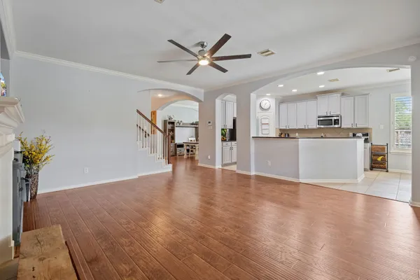 a view of a kitchen with a sink wooden floor and a window