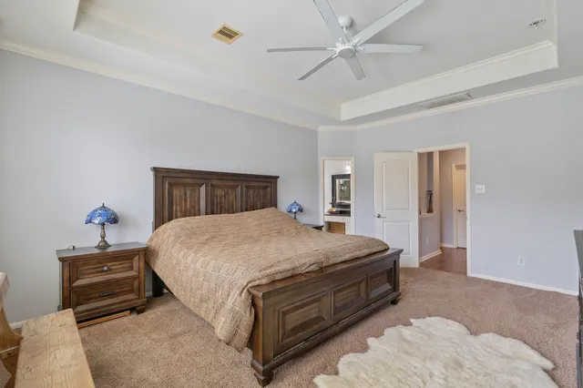 a bedroom with bed and a chandelier