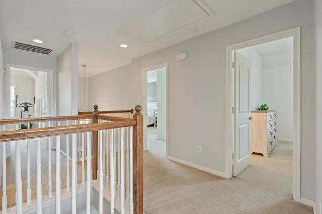 a bedroom with a bed chandelier and a window