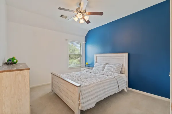 a view of a bedroom with a large bed and chandelier