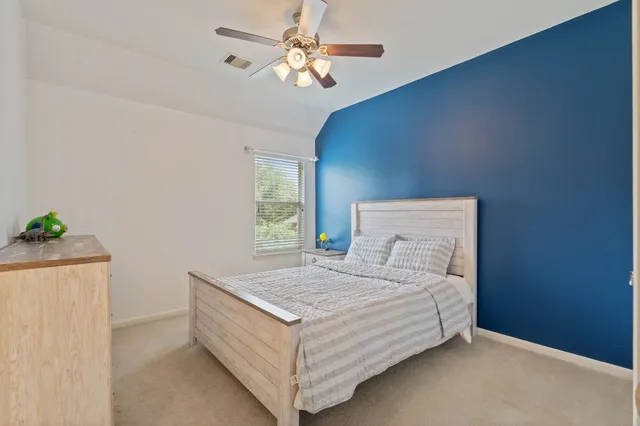 a view of a bedroom with a large bed and chandelier
