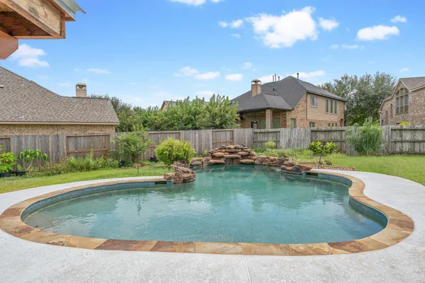 a view of a house with swimming pool and a yard