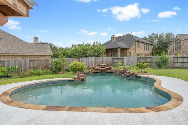 a view of a house with swimming pool and a yard