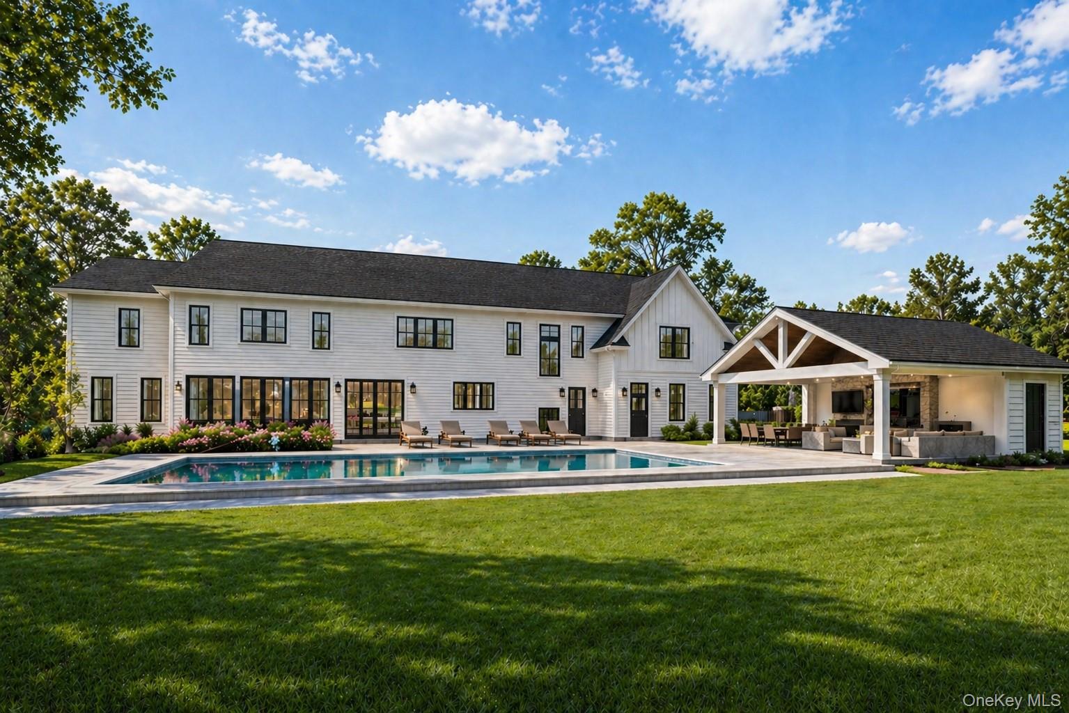 7 Hollow Ridge Road Armonk, NY 10504 - Photo 2 of 16 a front view of a house with a yard table and chairs