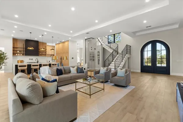a kitchen with a dining table chairs and white cabinets