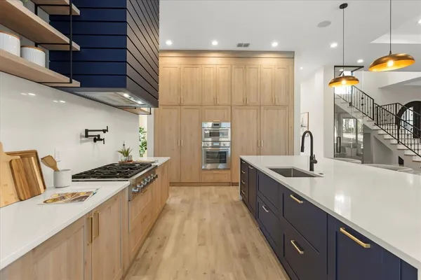 a dining room with furniture a chandelier and wooden floor