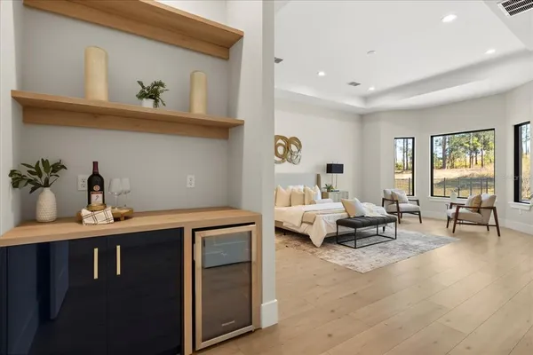 a living room with furniture a desk and chair with wooden floor