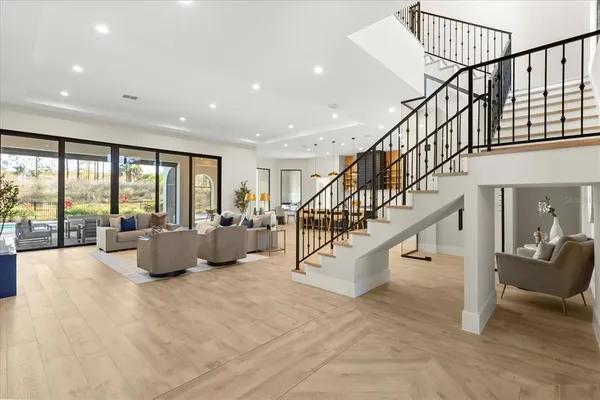 a living room with furniture and large windows