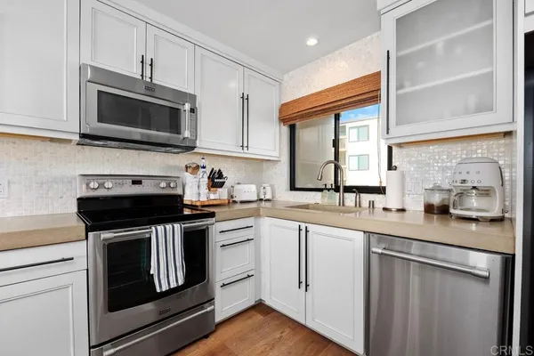 a kitchen with a sink cabinets and wooden floor