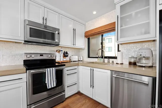 a kitchen with a sink cabinets and wooden floor