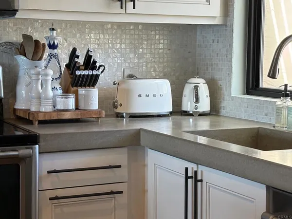 a bedroom with a bed and flat tv screen on the dresser