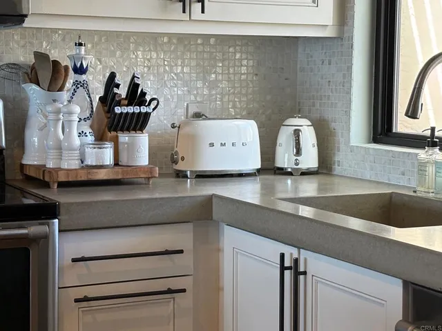 a bedroom with a bed and flat tv screen on the dresser