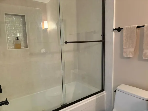 a bedroom with a bed and a book shelf