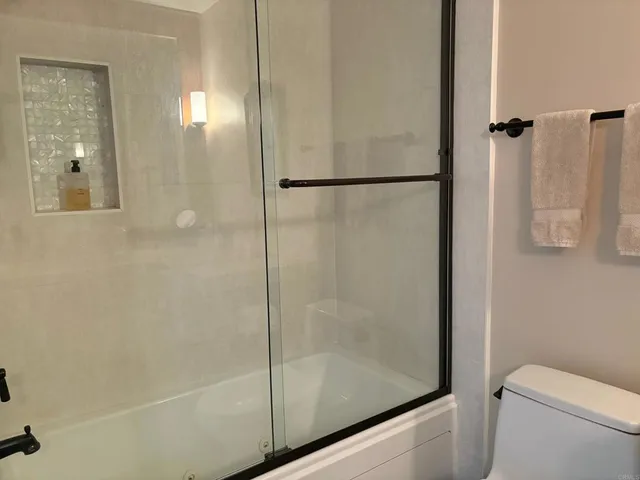 a bedroom with a bed and a book shelf