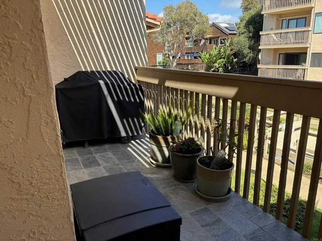 a view of a white house with a yard and garden