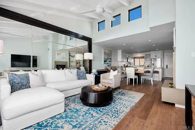 a living room with furniture and a view of kitchen
