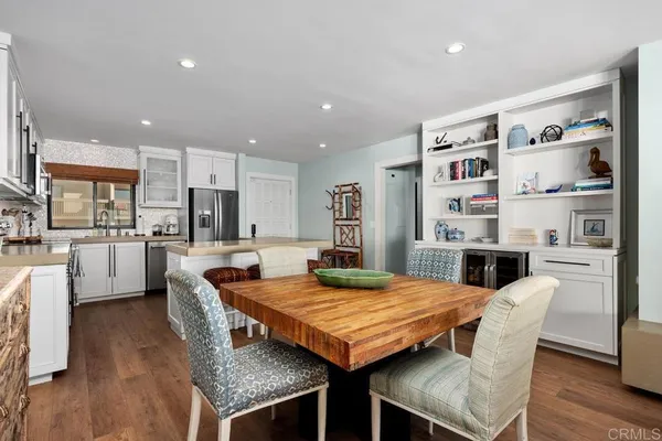 a kitchen with stainless steel appliances granite countertop a refrigerator a stove top oven a sink and dishwasher