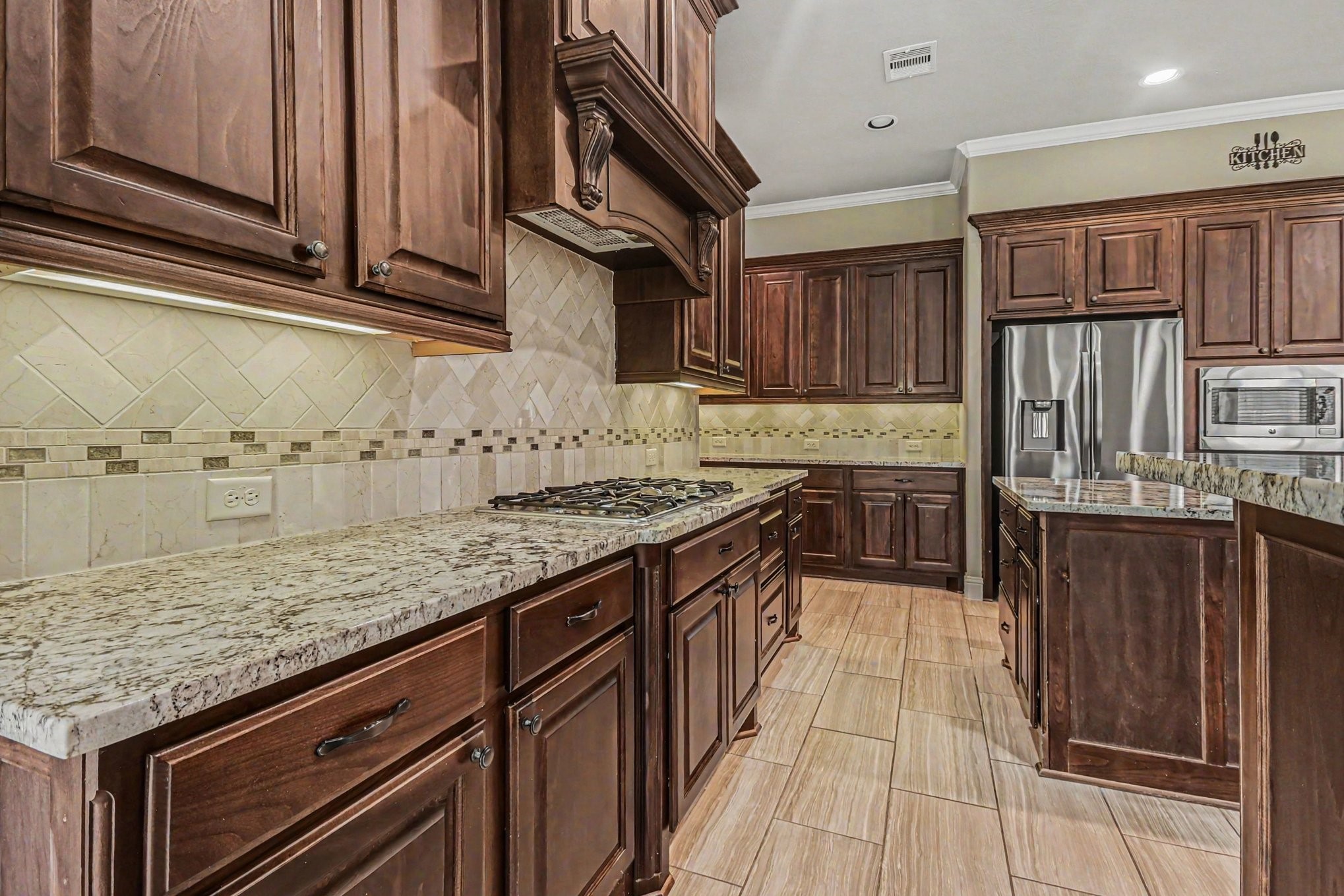 3310 Ralston Edge Lane Houston, TX 77059 - Photo 19 of 50 a kitchen with stainless steel appliances granite countertop a stove a sink and a microwave