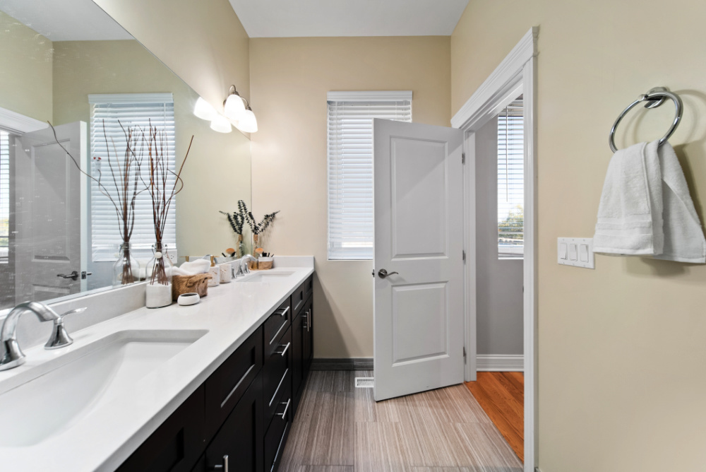 3336 West Irving Park Road, Unit 2 Chicago, IL 60618 - Photo 7 of 9 a bathroom with a double vanity sink and a mirror