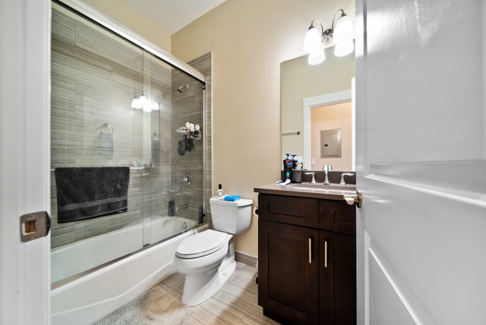 3336 West Irving Park Road, Unit 2 Chicago, IL 60618 - Photo 9 of 9 a bathroom with a sink a toilet and shower