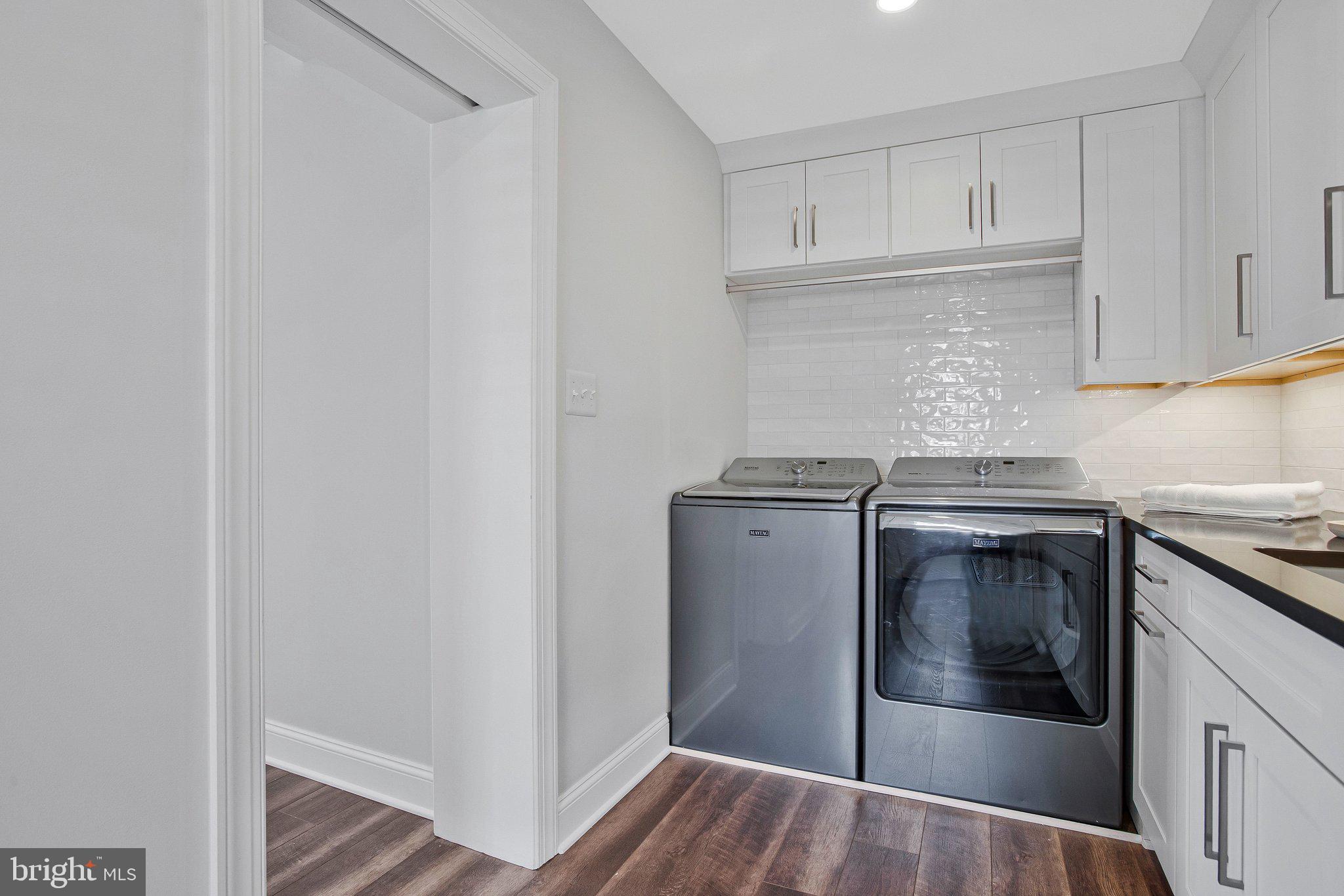 6146 Drum Point Road Deale, MD 20751 - Photo 27 of 75 a kitchen with granite countertop white cabinets and stainless steel appliances