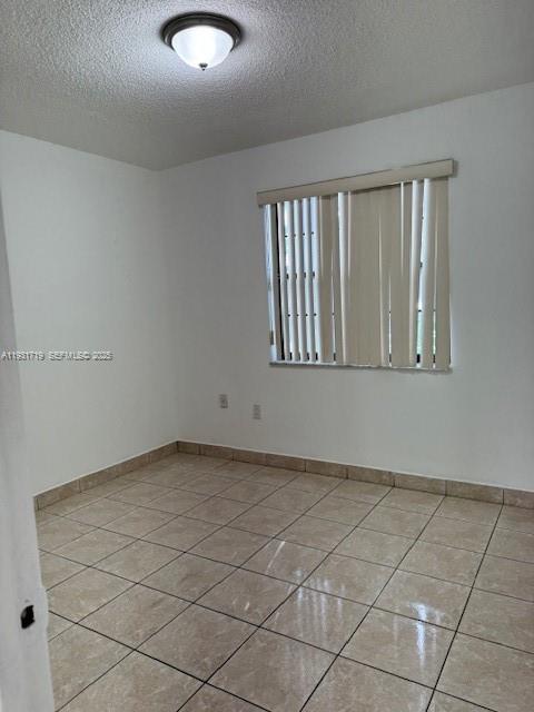 3804 Southwest 79th Avenue, Unit 77 Miami, FL 33155 - Photo 5 of 7 a view of an empty room with a window