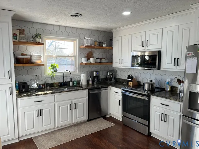 a bathroom with a sink toilet and window