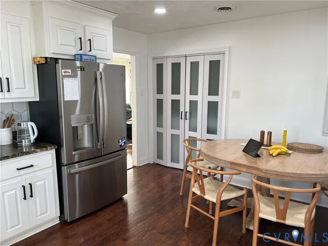 a bathroom with a granite countertop sink a toilet and shower