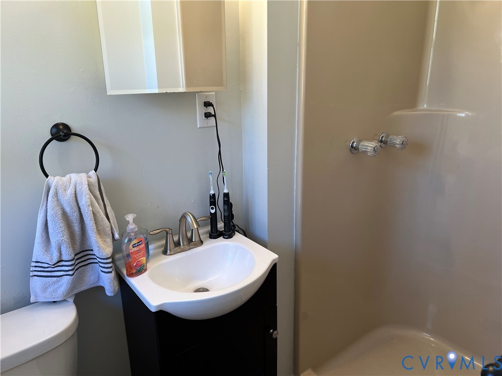 4192 Range Road Mechanicsville, VA 23111 - Photo 27 of 36 a bathroom with a sink a toilet and a mirror