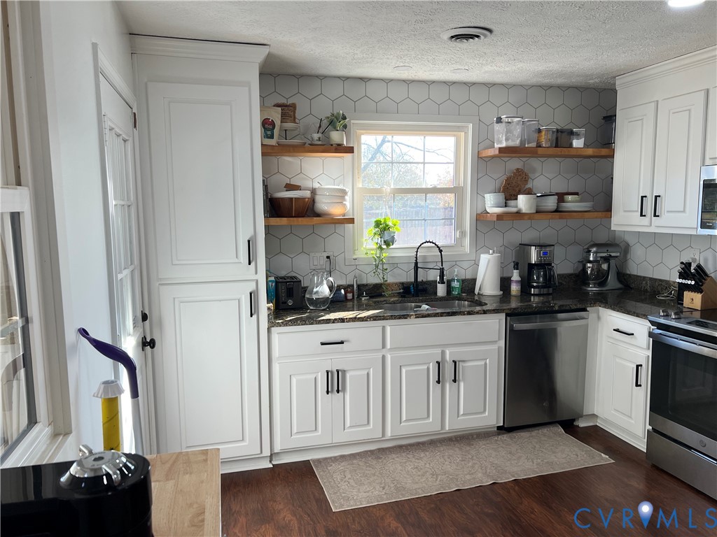 4192 Range Road Mechanicsville, VA 23111 - Photo 9 of 36 a kitchen with stainless steel appliances granite countertop a stove a sink and a refrigerator