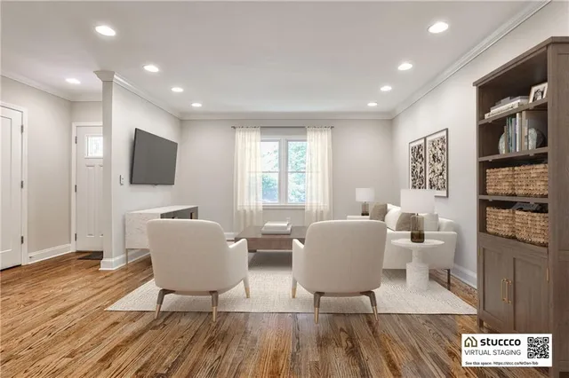 a living room with furniture a flat screen tv and a wooden floor